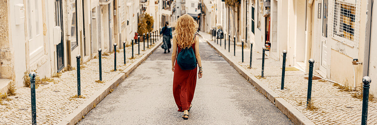Woman walking through streets of old city.
